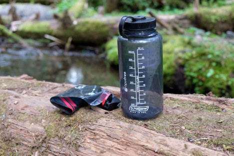 Two types of hot water bottles that hikers place inside sleeping bags inside on cold nights