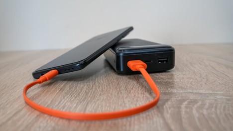 A portable power bank charging a phone