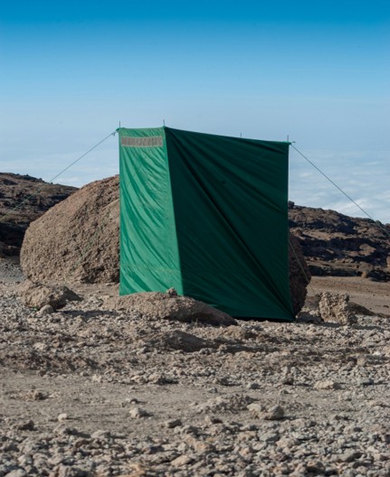 A clean portable private toilet tent at a mountain campsite