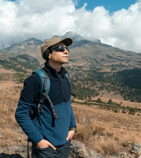 A stylish hiker wearing sunglasses on a sunny hiking trail