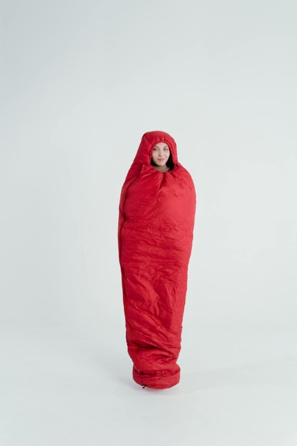 A lady inside a red sleeping bag