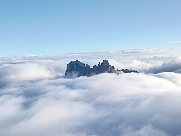 Mount Kenya peaks; Batian and Nelion piercing the clouds reached through technical mountain climbing