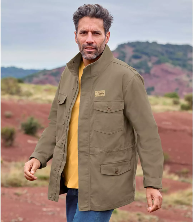 Safari traveller wearing a warm fleece jacket with a yellow shirt and blue jeans
